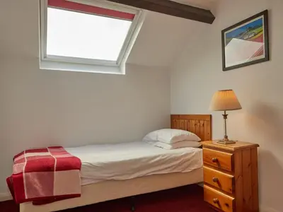 a bedroom with a bed with a window and a dresser at 8 Bed in Applethwaite SZ373 in Applethwaite