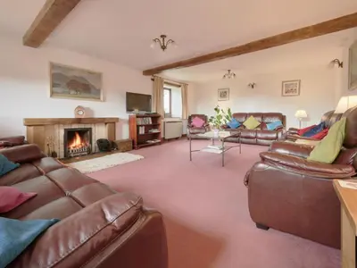a living room with leather furniture and a fireplace at 8 Bed in Applethwaite SZ373 in Applethwaite