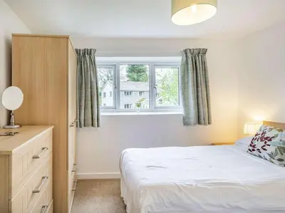 a bedroom with a bed and a window at 3 Bed in Keswick oc-sz446 in Portinscale
