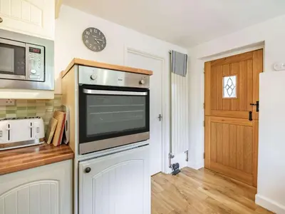 a kitchen with a microwave oven and a refrigerator at 3 Bed in Keswick oc-sz446 in Portinscale