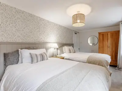 two white beds in a bedroom with a wall at 9 Bed in Keswick oc-sz238 in Keswick