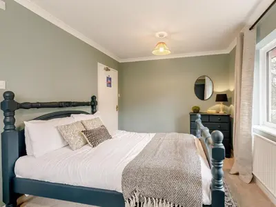 a bedroom with a bed and a window at 9 Bed in Keswick oc-sz238 in Keswick