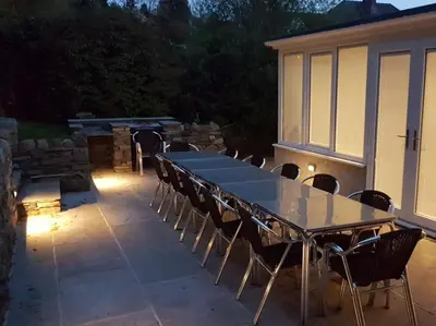 a table and chairs on a patio with lights at 9 Bed in Keswick oc-sz238 in Keswick