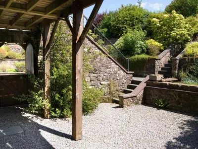 a bench sitting under a pavilion in a garden at 3 Bed in Egremont oc-sz230 in Hale