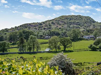 a green field with a mountain in the background at 3 Bed in Holmrook oc-sz414 in Santon Bridge