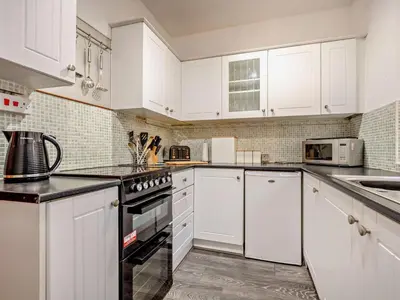 a white kitchen with white cabinets and appliances at 3 Bed in Holmrook oc-sz414 in Santon Bridge