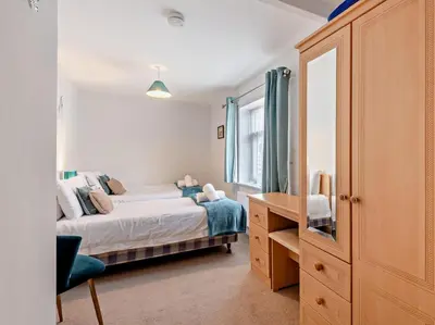 a bedroom with a bed and a dresser and a mirror at 2 Bed in Keswick oc-sz140 in Keswick