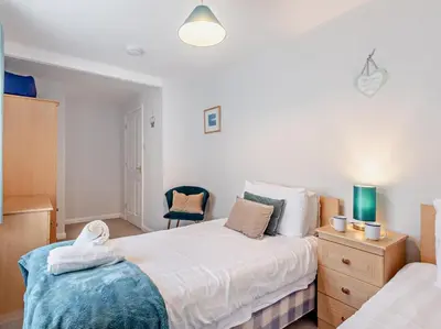 a bedroom with a bed and a chair in it at 2 Bed in Keswick oc-sz140 in Keswick