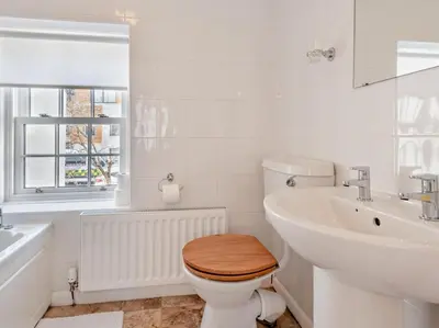 a white bathroom with a toilet and a sink at 2 Bed in Keswick oc-sz140 in Keswick