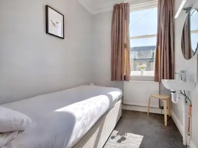 a bedroom with a bed and a sink and a window at 6 Bed in Keswick oc-sz389 in Keswick