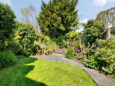 a garden with a table and chairs in the grass at 6 Bed in Keswick oc-sz389 in Keswick