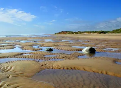 a beach with three large rocks in the sand at 2 Bed in Wasdale oc-tcsz436 in Santon Bridge