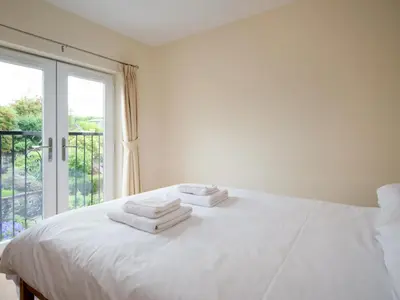 a white bedroom with a bed with towels on it at 3 Bed in Egremont oc-sz058 in Hale