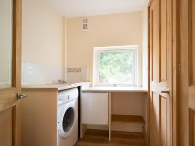 a laundry room with a washing machine and a window at 3 Bed in Egremont oc-sz058 in Hale