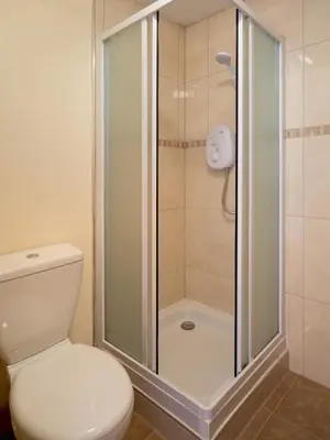 a bathroom with a shower with a toilet and a shower at 3 Bed in Egremont oc-sz058 in Hale
