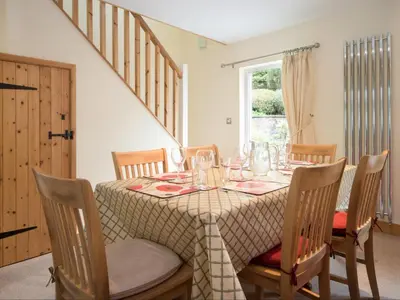 a dining room with a table with wine glasses on it at 3 Bed in Egremont oc-sz058 in Hale
