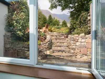 a window looking out at a stone wall at 3 Bed in Threlkeld SZ421 in Threlkeld