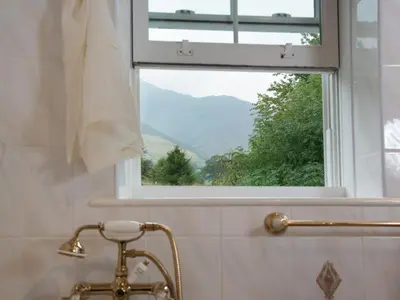 a bathroom with a window and a tub and a sink at 3 Bed in Threlkeld SZ421 in Threlkeld