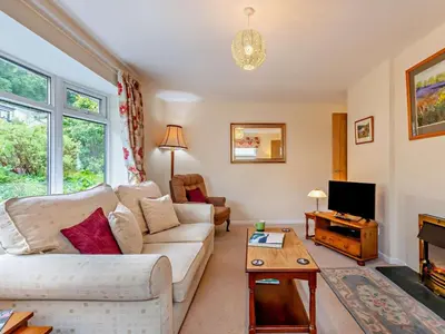 a living room with a white couch and a tv at 2 Bed in Keswick oc-sz008 in Keswick