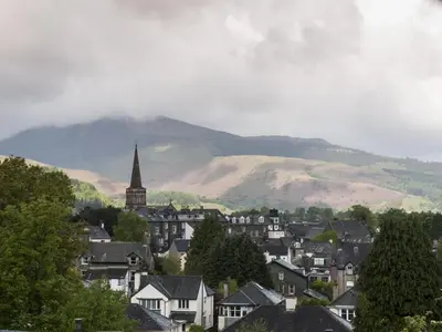 a town with a mountain in the background with houses at 2 Bed in Keswick oc-sz008 in Keswick