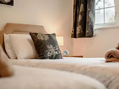 a bedroom with a bed with a pillow and a window at 2 Bed in Keswick oc-sz116 in Keswick