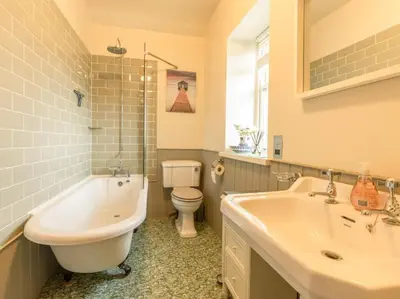 a bathroom with a tub and a sink and a toilet at 2 Bed in Threlkeld SZ082 in Threlkeld