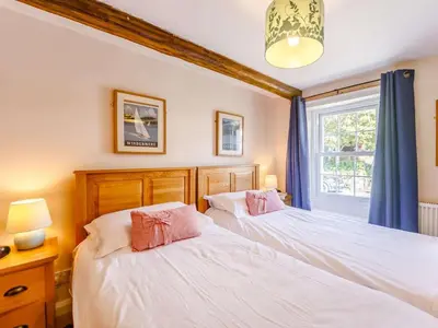 two beds in a bedroom with a window at 2 Bed in Keswick oc-sz341 in Portinscale