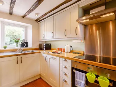 a kitchen with white cabinets and a stainless steel appliance at 2 Bed in Keswick oc-sz341 in Portinscale