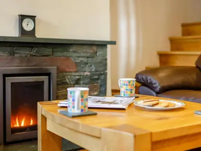 a living room with a coffee table and a fireplace at 2 Bed in Keswick oc-sz341 in Portinscale