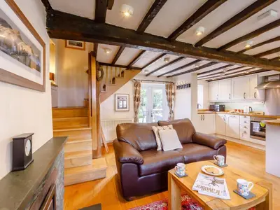 a living room with a leather couch and a table at 2 Bed in Keswick oc-sz341 in Portinscale