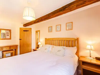 a bedroom with a large white bed and two lamps at 2 Bed in Keswick oc-sz341 in Portinscale