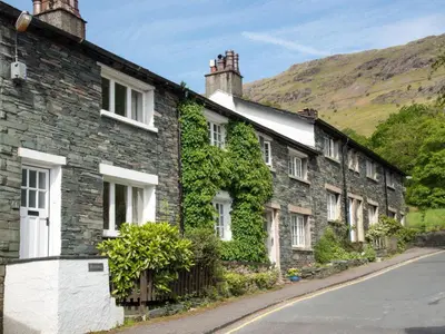 a row of houses with ivy on the side of a street at 2 Bed in Keswick oc-sz068 in Rosthwaite