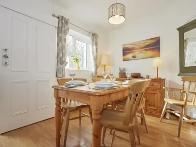 a dining room with a wooden table and chairs at 2 Bed in Keswick oc-sz068 in Rosthwaite