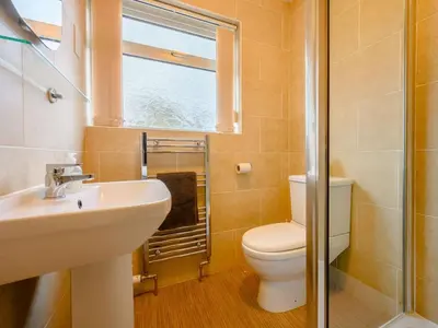 a bathroom with a toilet and a sink and a window at 1 Bed in Keswick SZ133 in Keswick