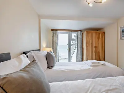 a bedroom with two beds and a window at 2 Bed in Ravenglass SZ409 in Ravenglass