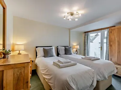 a bedroom with two beds and a desk and a window at 2 Bed in Ravenglass SZ409 in Ravenglass