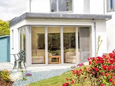 a screened in porch of a house with a chair at 4 Bed in Keswick SZ267 in Keswick