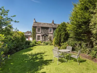 a table and chairs in front of a house at 2 Bed in Keswick oc-sz415 in Bassenthwaite