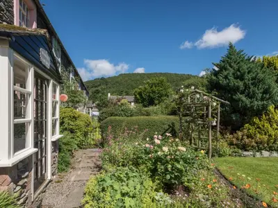 a garden outside a house with a hill in the background at 2 Bed in Keswick oc-sz415 in Bassenthwaite