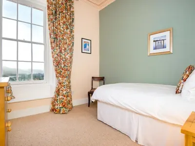a bedroom with a bed and a window with a curtain at 3 Bed in Applethwaite SZ168 in Applethwaite