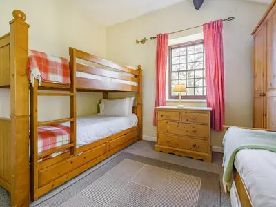 a bedroom with two bunk beds and a window at 3 Bed in Keswick oc-sz065 in Applethwaite
