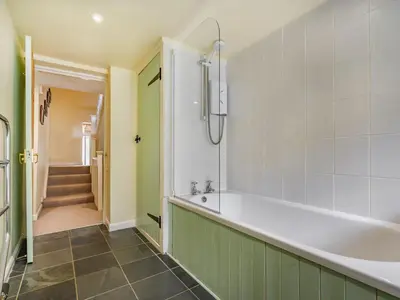 a bathroom with a bath tub and a hallway at 3 Bed in Keswick oc-sz065 in Applethwaite