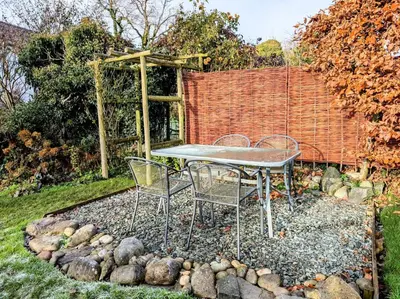 two chairs and a table in a garden at 2 Bed in Bassenthwaite SZ381 in Bassenthwaite Lake