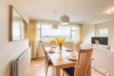a dining room with a table and chairs and a couch at 2 Bed in Bassenthwaite SZ381 in Bassenthwaite Lake