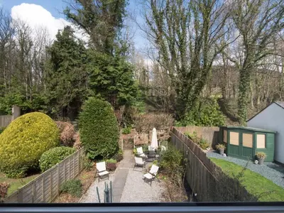 a garden with a fence and chairs and a fence at 3 Bed in Keswick SZ547 in Keswick