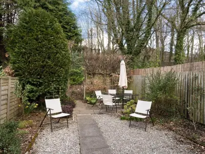a patio with a table and chairs and an umbrella at 3 Bed in Keswick SZ547 in Keswick