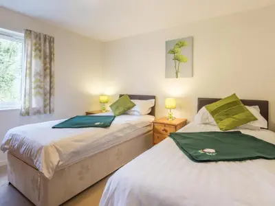 a bedroom with two beds with green towels on them at 3 Bed in Keswick SZ547 in Keswick