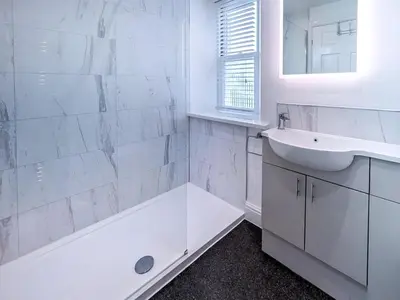 a white bathroom with a tub and a sink at 2 Bed in Keswick oc-sz490 in Keswick
