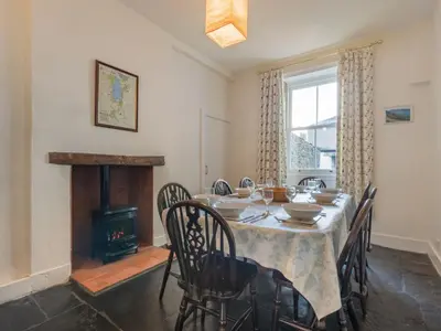 a dining room with a table and a fireplace at 3 Bed in Keswick SZ187 in Keswick