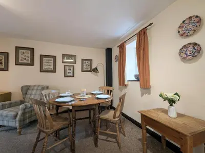 a living room with a wooden table and chairs at 2 Bed in Cockermouth oc-sz136 in Lorton
